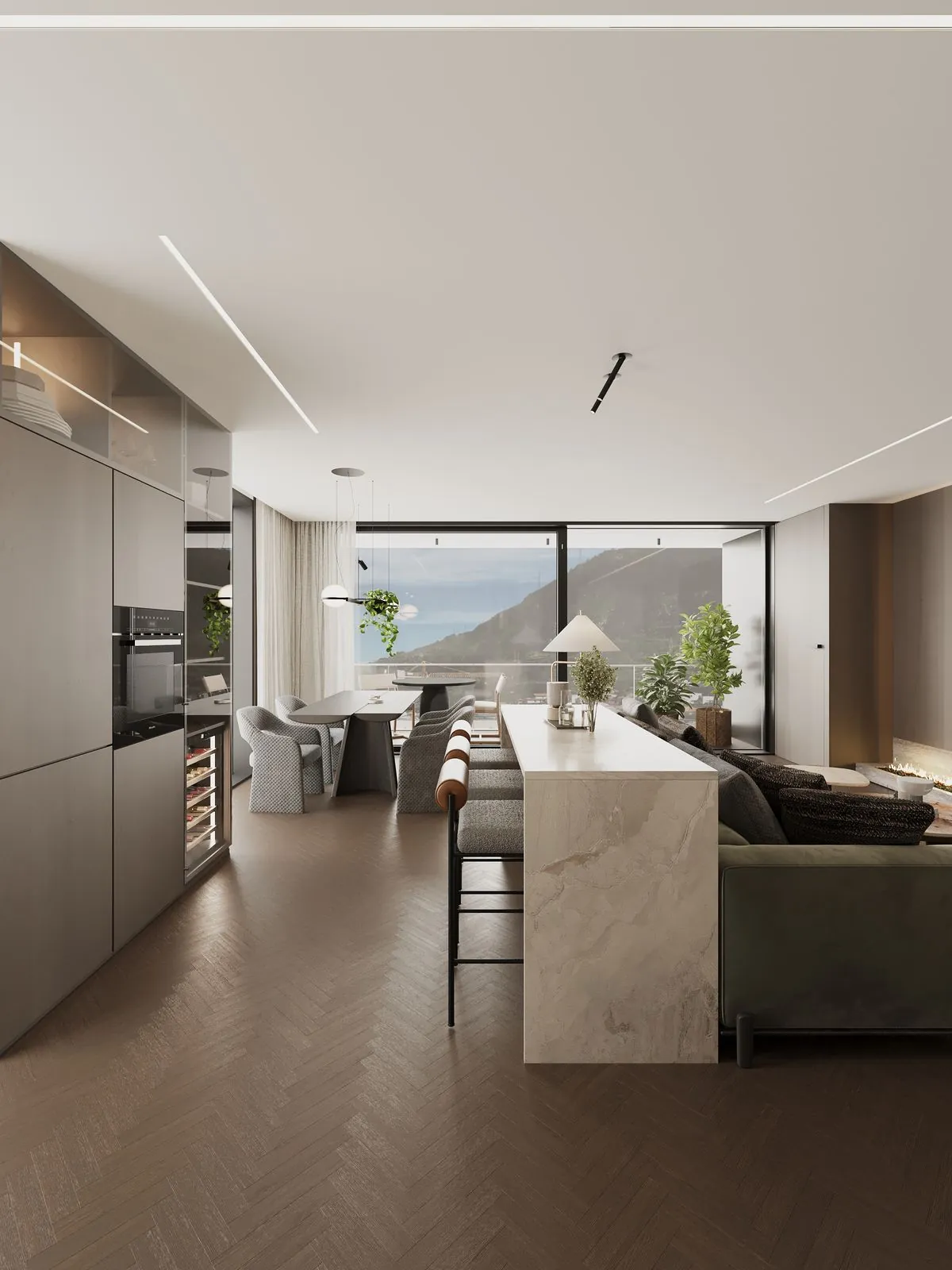 Tall kitchen units with ovens, the stone island and the dining table by the window