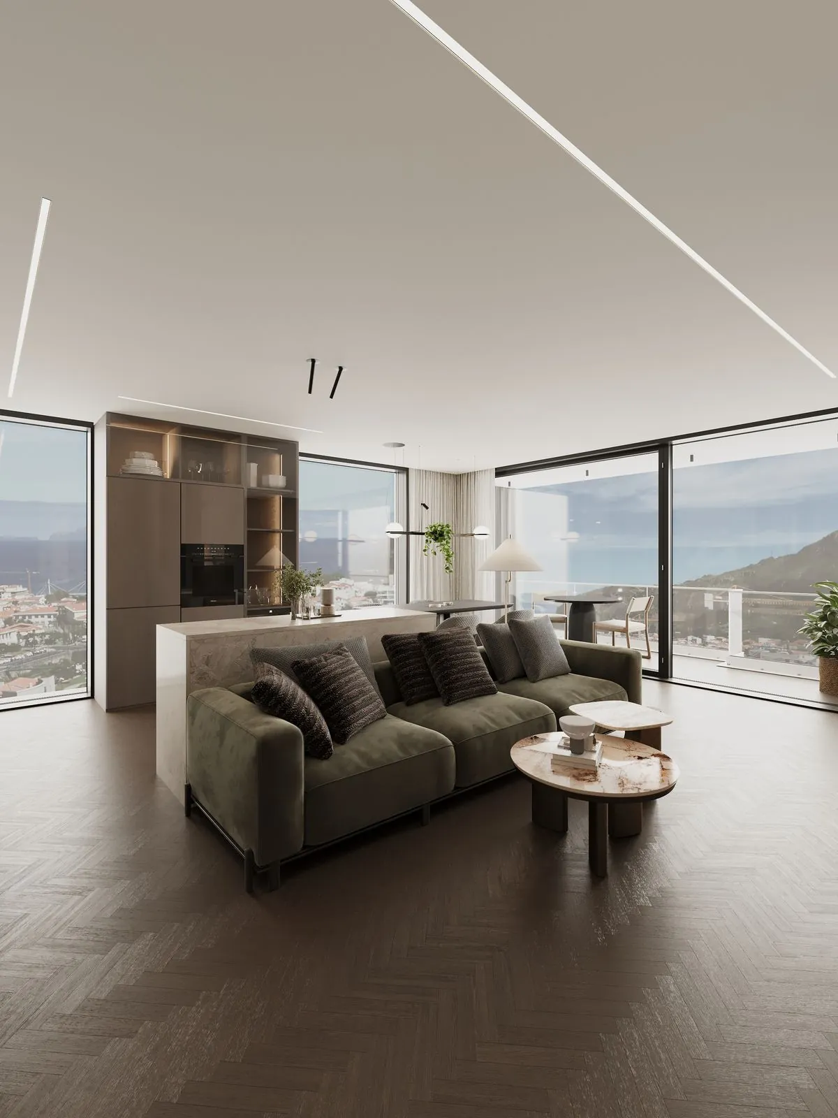 The corner of the living room with glass on two sides, the sofa and the terrace, the sea and the mountain beyond