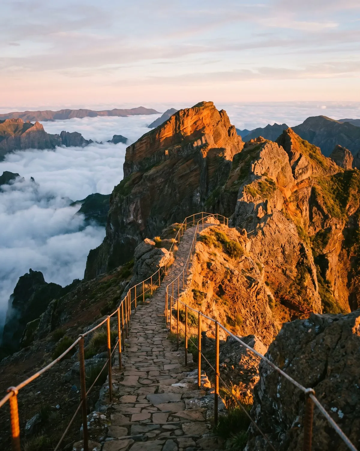 The ridge path at Pico do Arieiro at sunrise above a sea of clouds