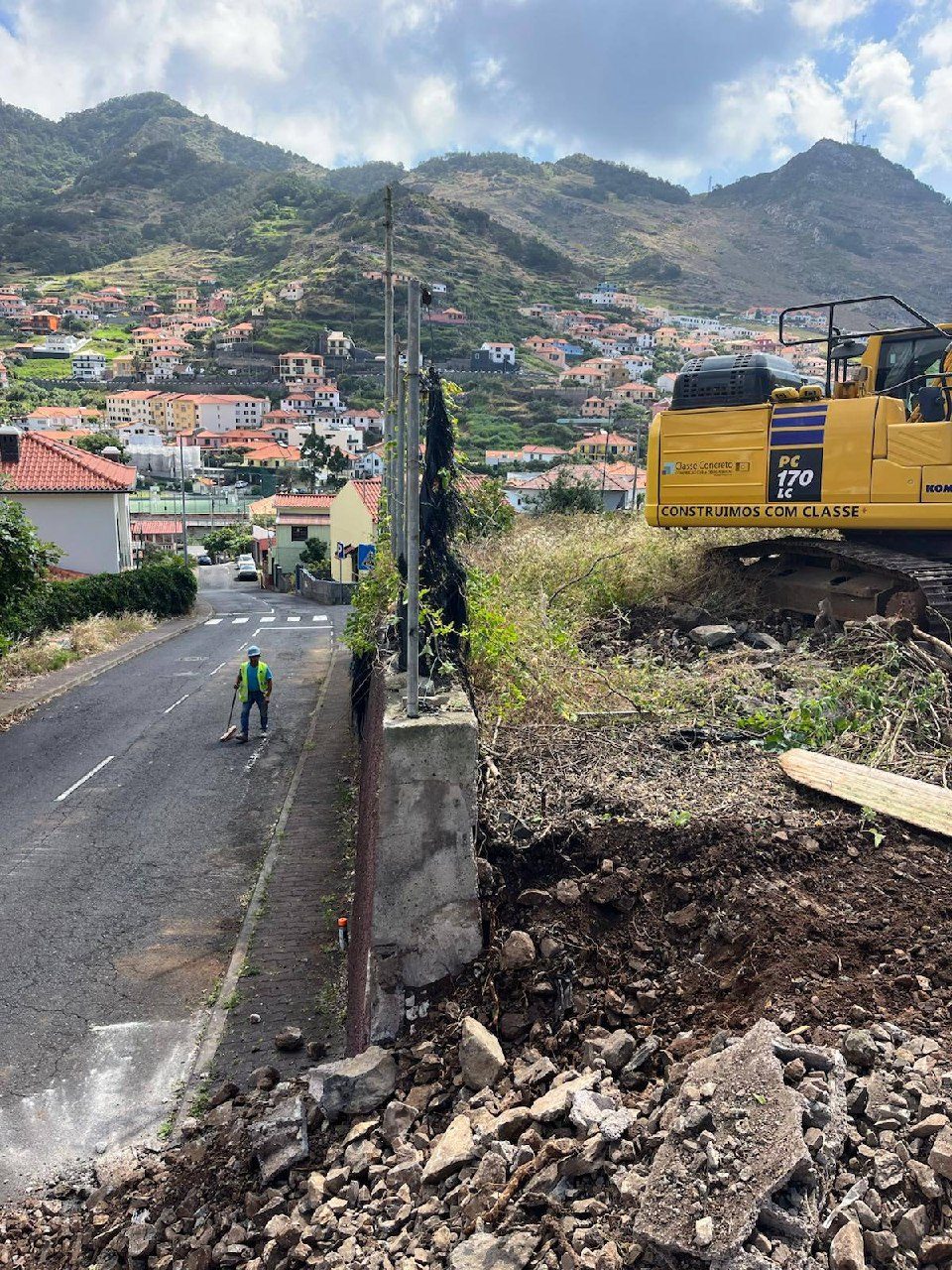 The old wall along the road is taken down