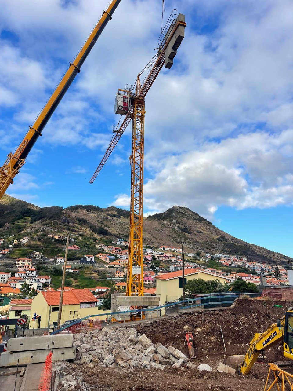 Crane and excavator at work together