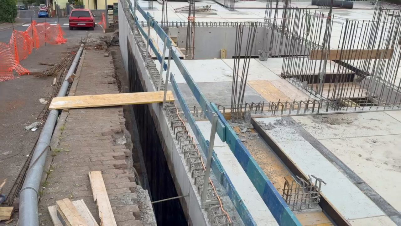 Along the edge of the garage level